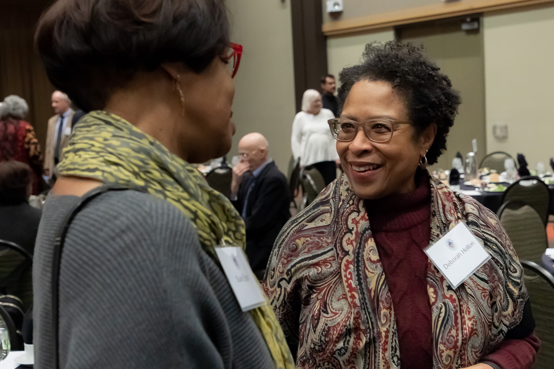 Deborah Holton, School for New Learning, right, talks with fellow honorees as DePaul University faculty and staff members are honored for their 25 years of service during a luncheon, Tuesday, Nov. 13, 2018, at the Lincoln Park Student Center. The honorees were recognized by A. Gabriel Esteban, Ph.D., president of DePaul, and will have their names added to plaques located on the Loop and Lincoln Park Campuses. (DePaul University/Jeff Carrion)